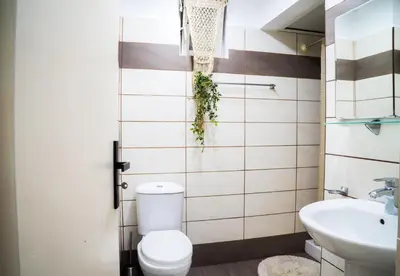 a bathroom with a toilet and a sink at Mousiko in Faliraki