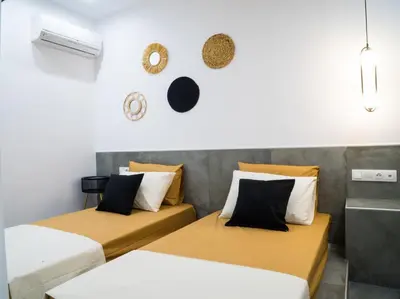 a room with two beds and a wall at Mousiko in Faliraki