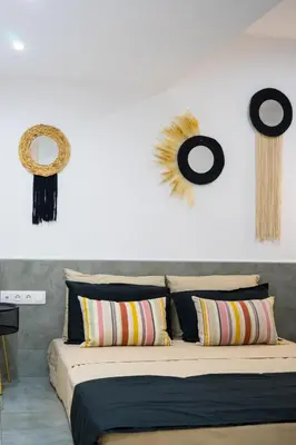 a bedroom with a bed and some decorations on the wall at Mousiko in Faliraki