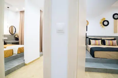 a bedroom with two beds and a mirror at Orama in Faliraki