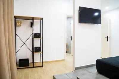 a room with a mirror and a tv on a wall at Orama in Faliraki