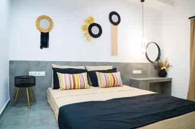 a bedroom with a bed and some mirrors on the wall at Orama in Faliraki