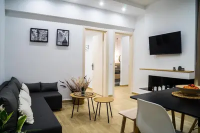 a living room with a couch and a table at Orama in Faliraki