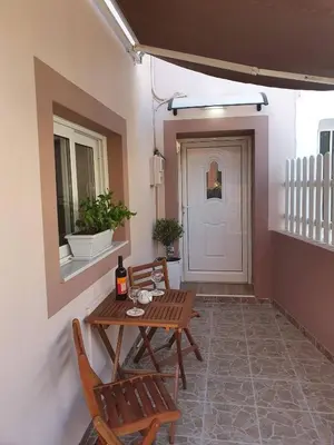 a patio with a table and chairs and a door at FANES HOUSE in Phanaes