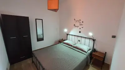 a bedroom with a bed and a mirror on the wall at FANES HOUSE in Phanaes
