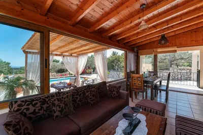 a living room with a couch and a table at Sea Rock Villa Rodos in Archangelos
