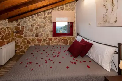 a bedroom with a bed with red roses on it at Sea Rock Villa Rodos in Archangelos