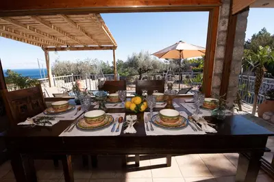 a wooden table with a table cloth on top of a table at Sea Rock Villa Rodos in Archangelos