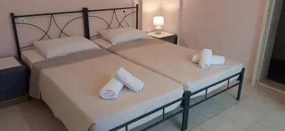 two beds in a bedroom with towels on them at Marilen in Livadia
