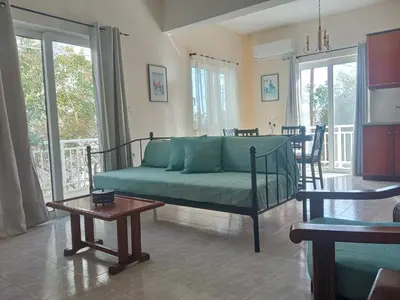a living room with a couch and a table at Marilen in Livadia