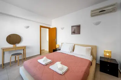 a bedroom with a large bed with towels on it at Adore Lindos Villa in Líndos