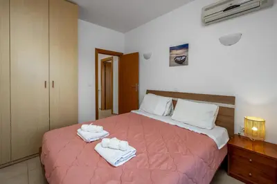 a bedroom with a bed with towels on it at Adore Lindos Villa in Líndos