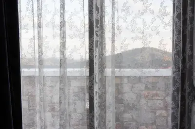 a window with a view of a stone wall at Roccia di Isidoro in Áyios Isídhoros