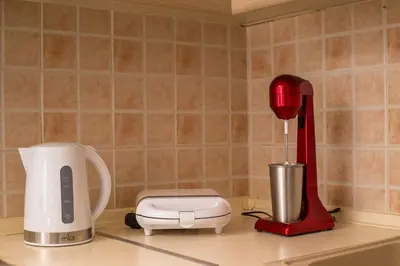 a kitchen counter with a red mixer and a blender at Haraki Bay Loft (by haris) in Haraki