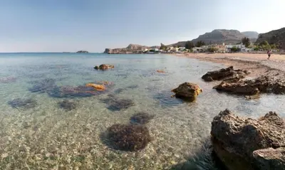 a beach with rocks in the water and the ocean at Thalassia Avra Stegna Beach in Archangelos