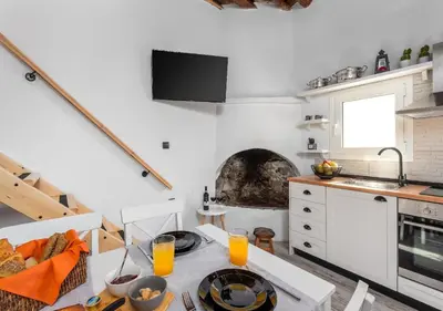 a kitchen with a table with glasses of orange juice at Lotza Traditional House Salakos in Sálakos