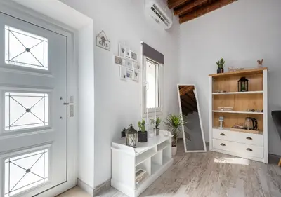 a white room with a white door and a shelf at Lotza Traditional House Salakos in Sálakos