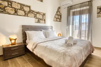 a bedroom with a large bed and a window at Villa Crypty in Soroni