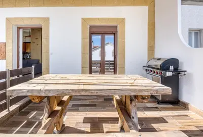 a wooden table in a room with a grill at Villa Crypty in Soroni