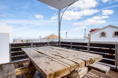 a wooden table on the roof of a building at Villa Crypty in Soroni
