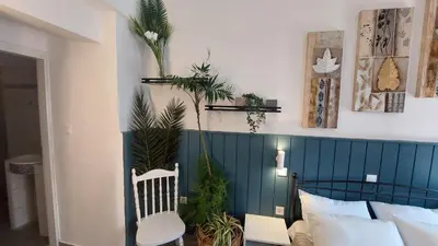 a bedroom with a bed with plants on the wall at OLD TOWN TALES apartments in Rhodes Town