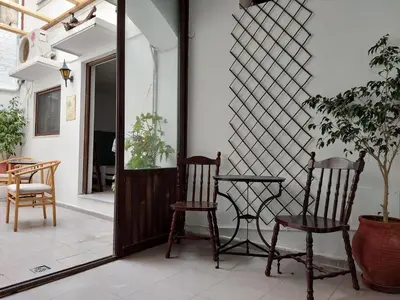 a room with two chairs and a table and a mirror at OLD TOWN TALES apartments in Rhodes Town