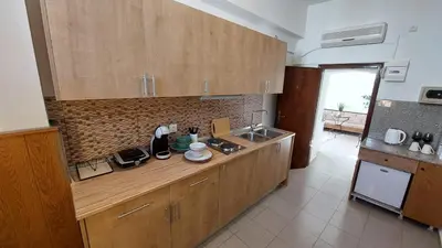 a kitchen with wooden cabinets and a sink and a counter at OLD TOWN TALES apartments in Rhodes Town