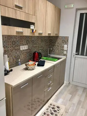 a kitchen with wooden cabinets and a counter top at RHODIAN TREASURE Spiridione apartment in Rhodes Town