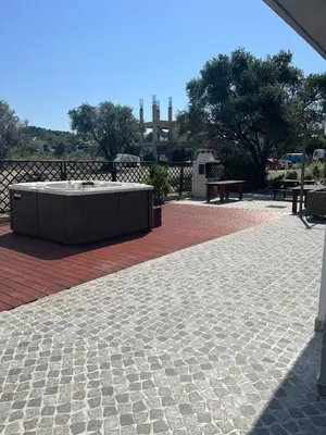 a patio with a table and a bench in a park at RHODIAN TREASURE Spiridione apartment in Rhodes Town