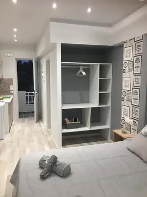 a bedroom with a white bed with a pair of shoes on it at RHODIAN TREASURE Spiridione studio 1 in Faliraki