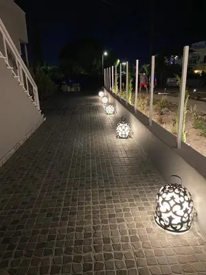 a row of lights on a sidewalk at night at RHODIAN TREASURE Spiridione studio 1 in Faliraki