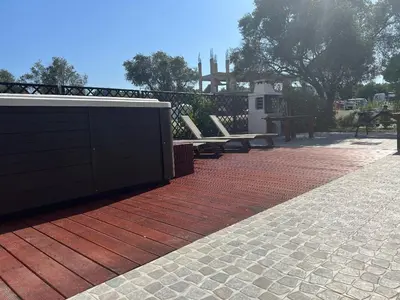 a brick patio with a bench and a fence at RHODIAN TREASURE Spiridione studio 1 in Faliraki