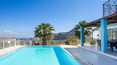 a swimming pool in a villa with a mountain in the background at Villa Selene in Archangelos