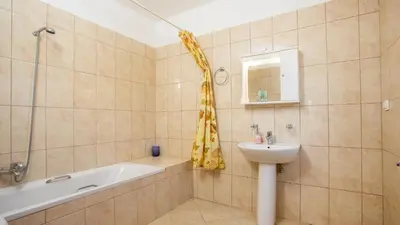 a bathroom with a tub and a sink and a shower at Villa Selene in Archangelos