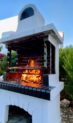 a brick oven with a fire inside of it at Villa Selene in Archangelos