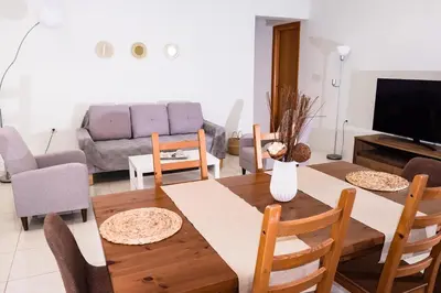 a living room with a table and a couch at Masefa villa in Ialyssos