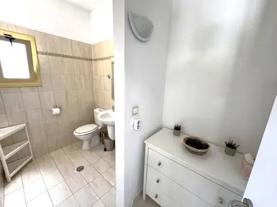 a bathroom with a toilet and a sink at Masefa villa in Ialyssos