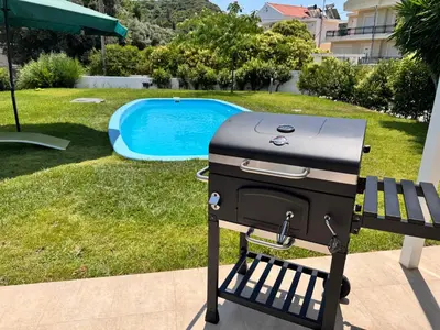 a grill sitting on a bench next to a pool at Masefa villa in Ialyssos