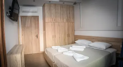 a bedroom with a bed with towels on it at Seaside Luxury Apartments Kremasti in Kremasti