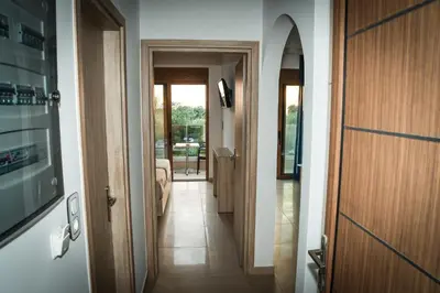 a hallway with a door leading to a room at Seaside Luxury Apartments Kremasti in Kremasti