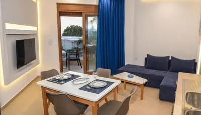 a living room with a table and a couch at Seaside Luxury Apartments Kremasti in Kremasti