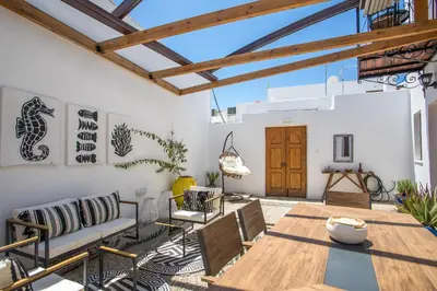 a patio with a wooden table and chairs at Villa Sakura in Líndos