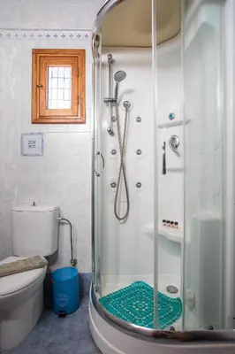 a shower with a glass door in a bathroom at Villa Sakura in Líndos