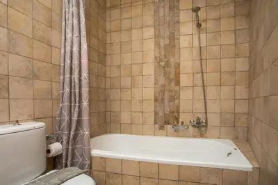 a bathroom with a bath tub and a toilet at Villa Sakura in Líndos