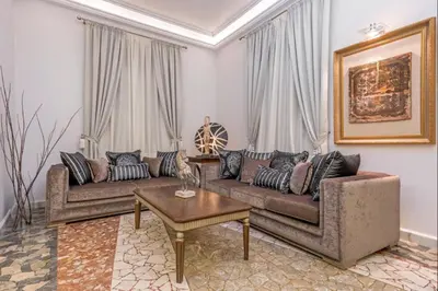 a living room with two couches and a table at Arhondiko Apartment VS Rhodes Town in Rhodes Town