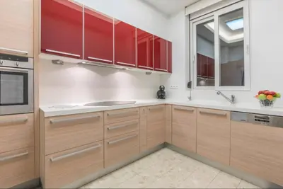 a kitchen with wooden cabinets and a window at Arhondiko Apartment VS Rhodes Town in Rhodes Town