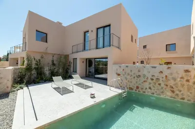 a villa with a swimming pool and a house at Nisi Living Concept in Ialyssos