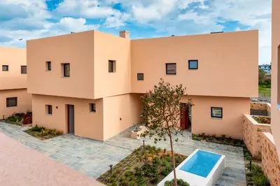 an exterior view of a house with a swimming pool at Nisi Living Concept in Ialyssos