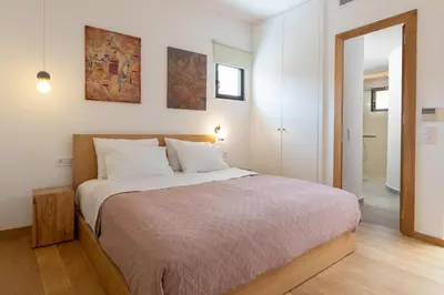a bedroom with a large bed with white pillows at Nisi Living Concept in Ialyssos