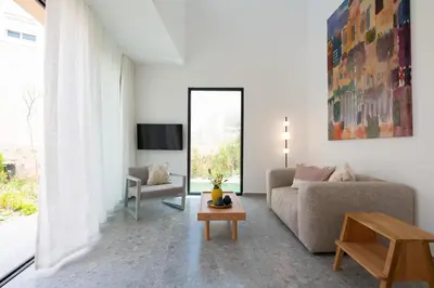 a living room with a couch and a table at Nisi Living Concept in Ialyssos